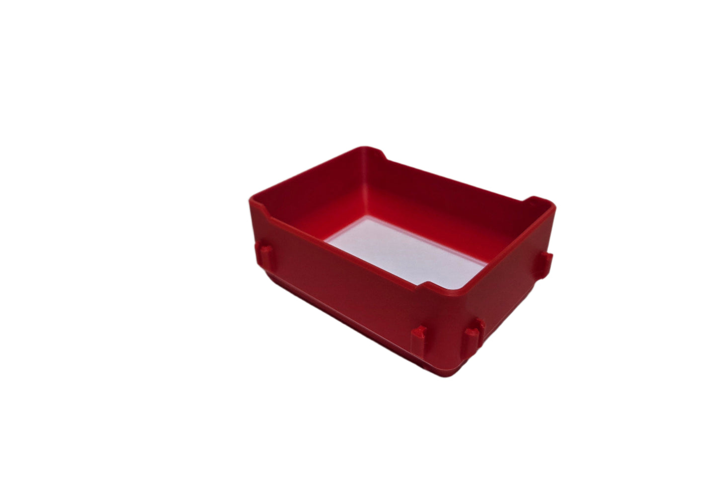 Red plastic box with a white label on a white background