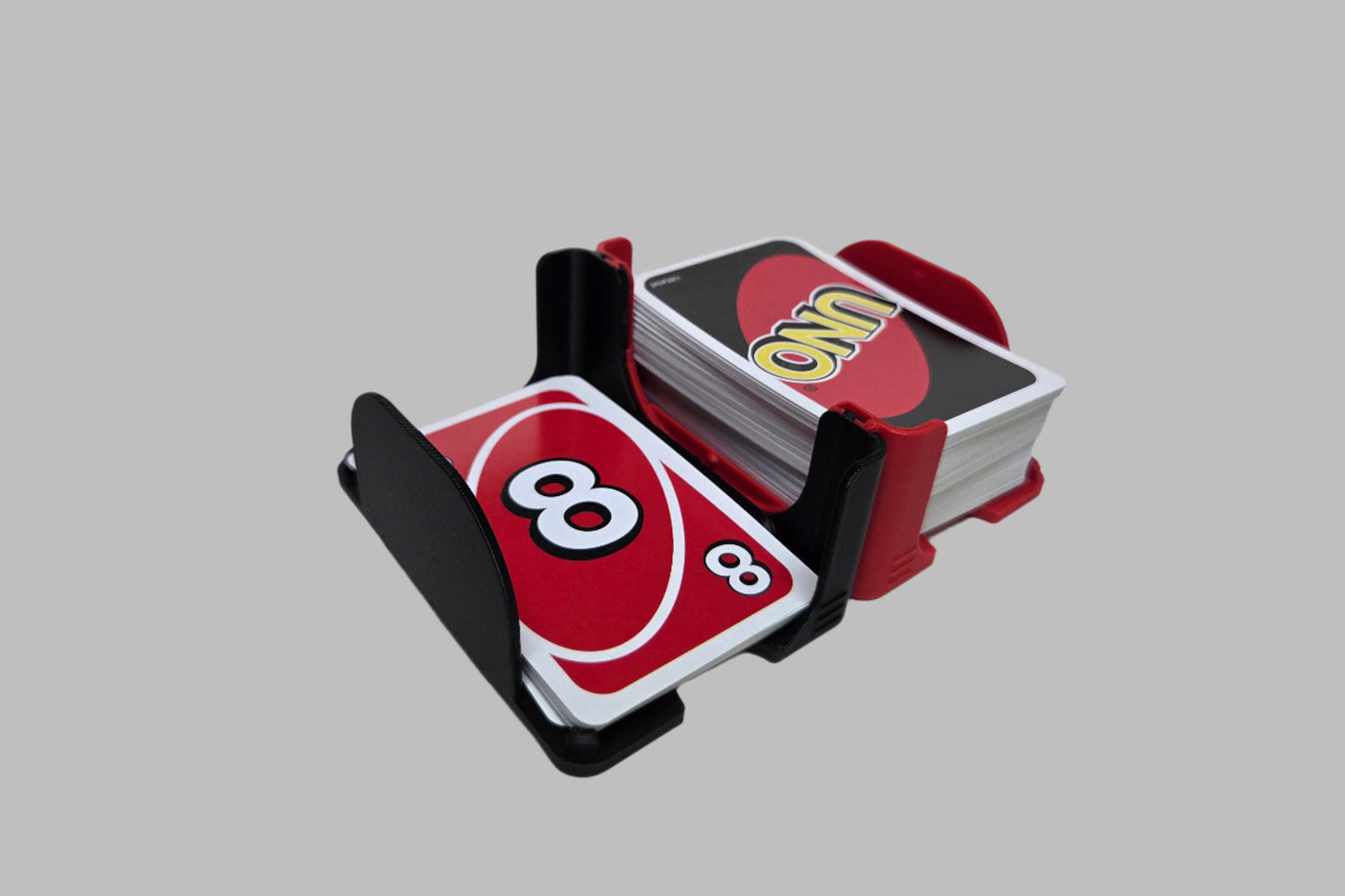 Two connected side by side card trays with Uno cards on a white background