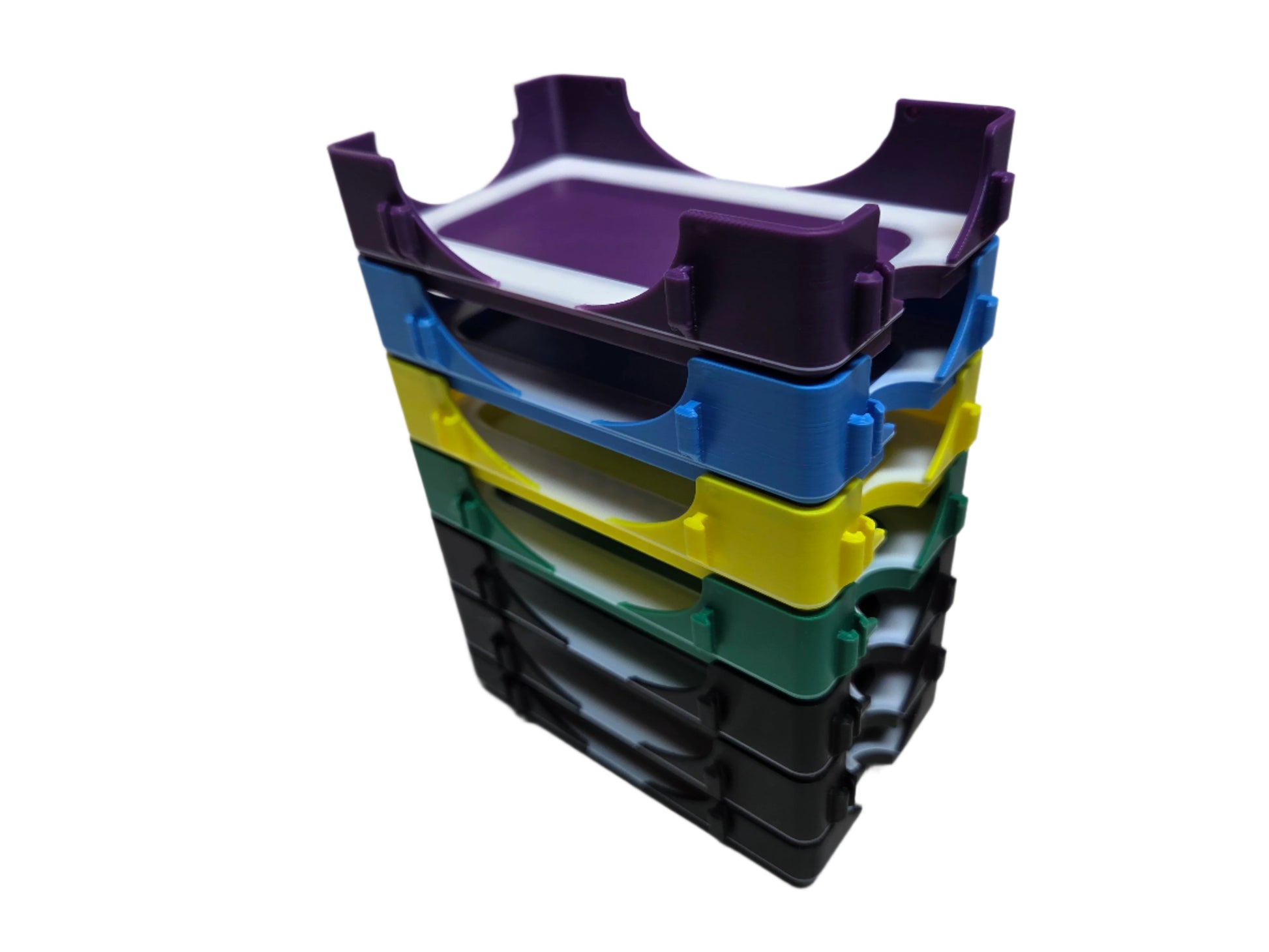 Stack of colorful plastic trays on a white background