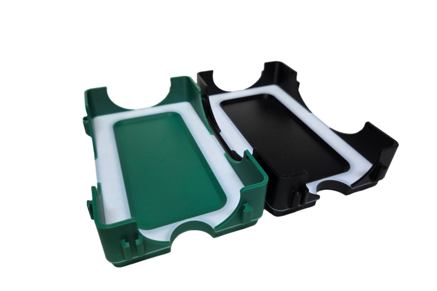 Two plastic holders, one green and one black, on a white background
