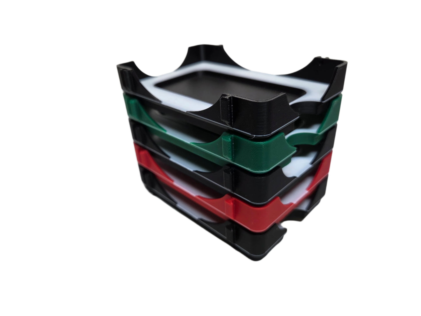 Stack of black, green, and red trays on a white background