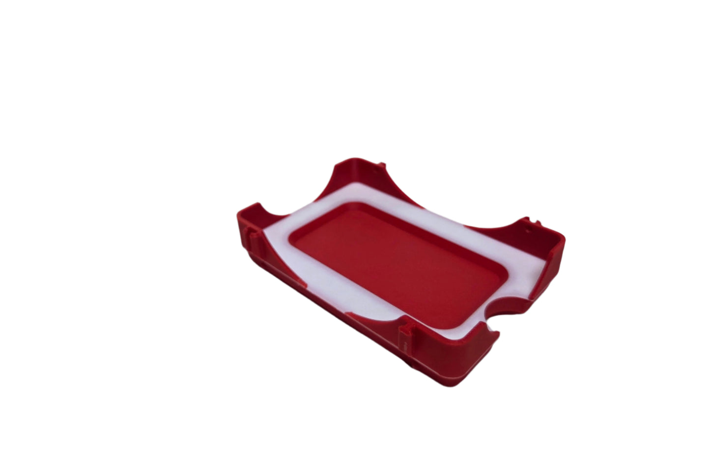 Red and white plastic component on a white background