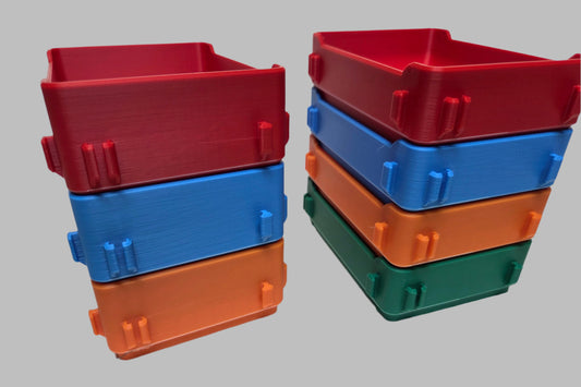 Stacks of red, blue, and green storage bins on a white background